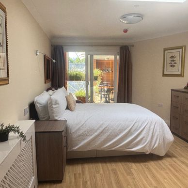 Cozy bedroom with large bed and sliding glass doors.
