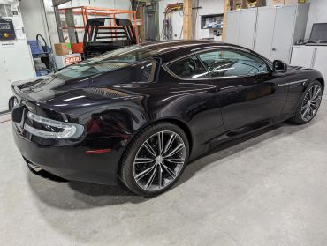 Sleek black sports car parked indoors.