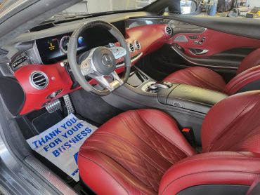 Luxury car interior with red leather seats.