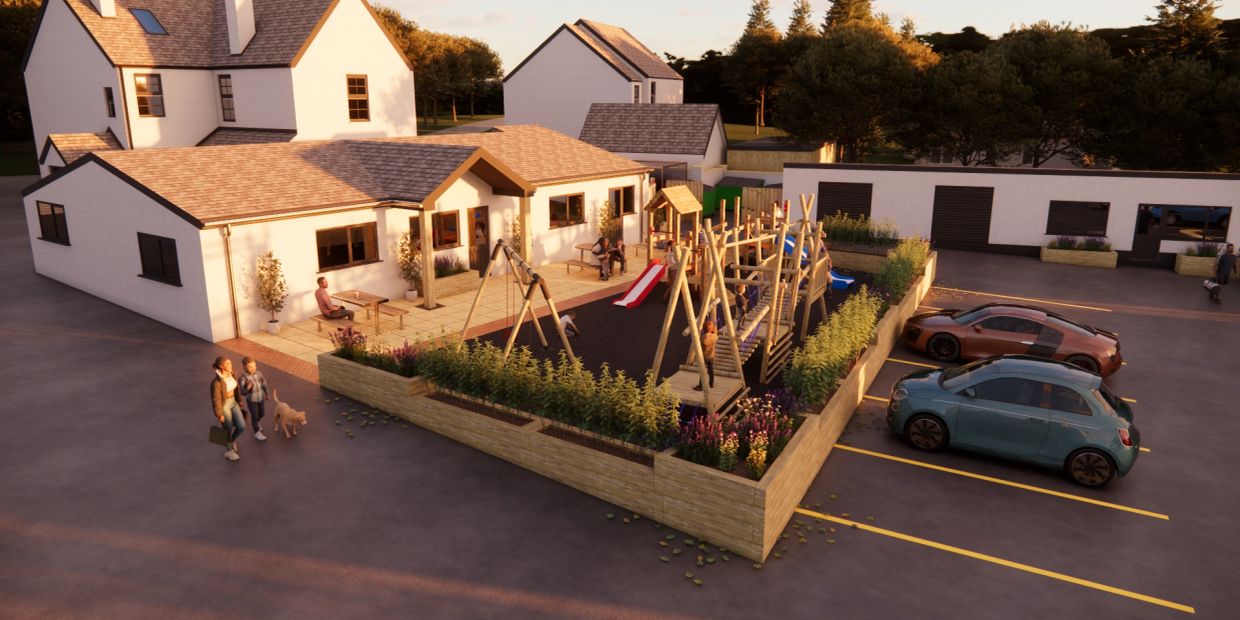 Playground next to modern houses with people and parked cars.