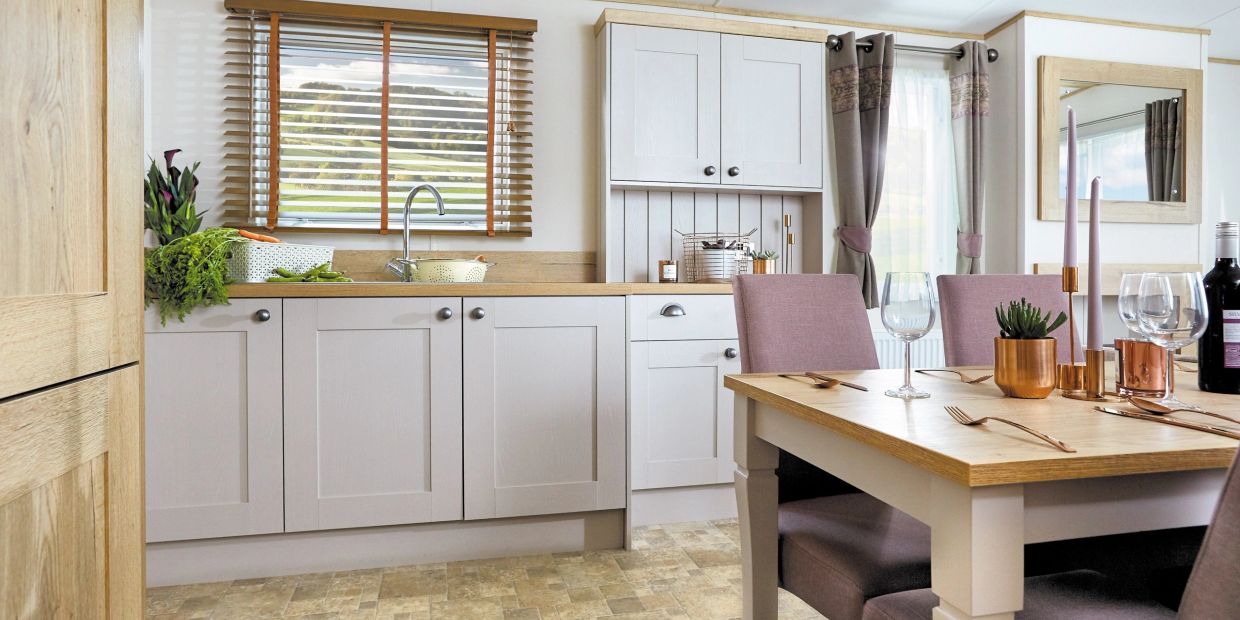 Modern kitchen with dining area and natural light.