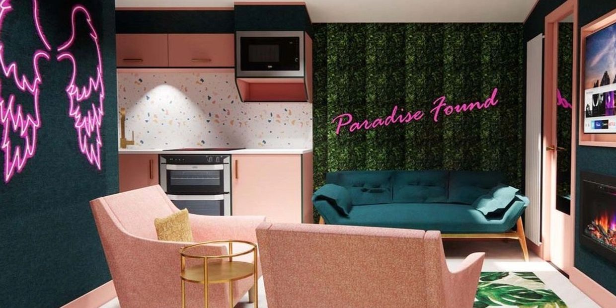 Cozy modern living room with pink and teal decor.