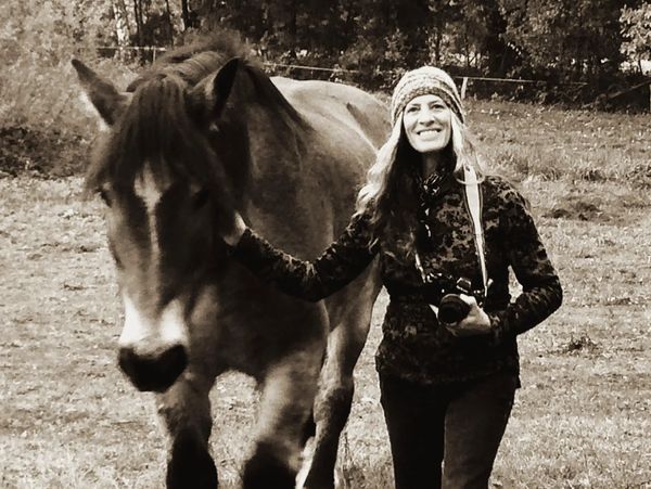 The photographer, Dona Bollard in Germany with a horse model.