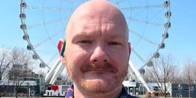 Man with a Ferris wheel in the background.