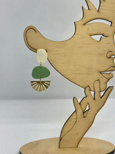 Abstract dangle earrings on wooden stand