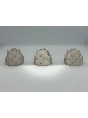 Three small concrete lotus flowers