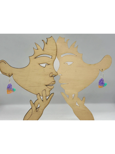 Abstract earrings on mirrored wooden display