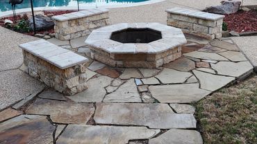Fire pit next to swimming pool.