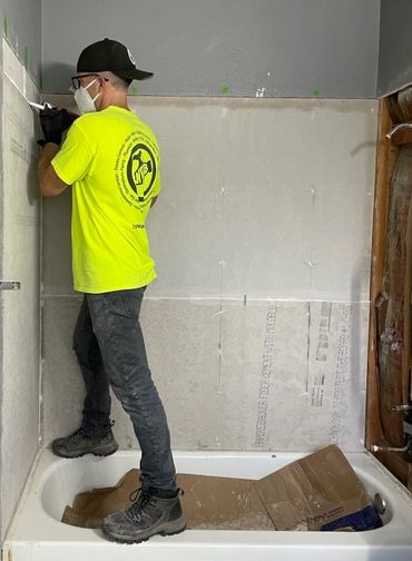 Shower remodel in rental: Replaced old tile and backer board with Hardie Board and new tile.