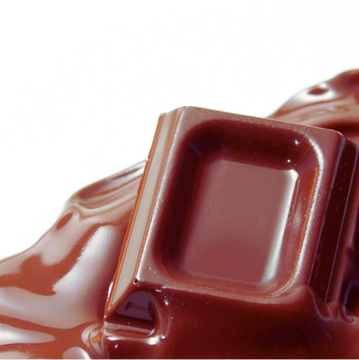 A decadent bar of chocolate that is melting.