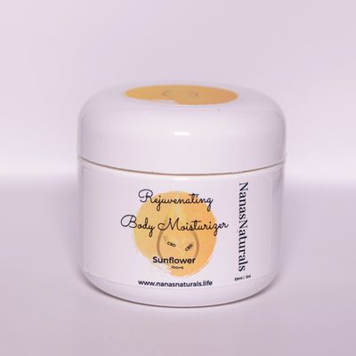 A white jar wrapped in a classy label of Nana's sunflower scented rejuvenating body moisturizer 2oz.