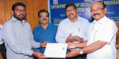 Four men at a certificate presentation event.