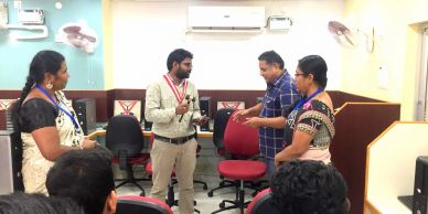Four people having a discussion in an office.