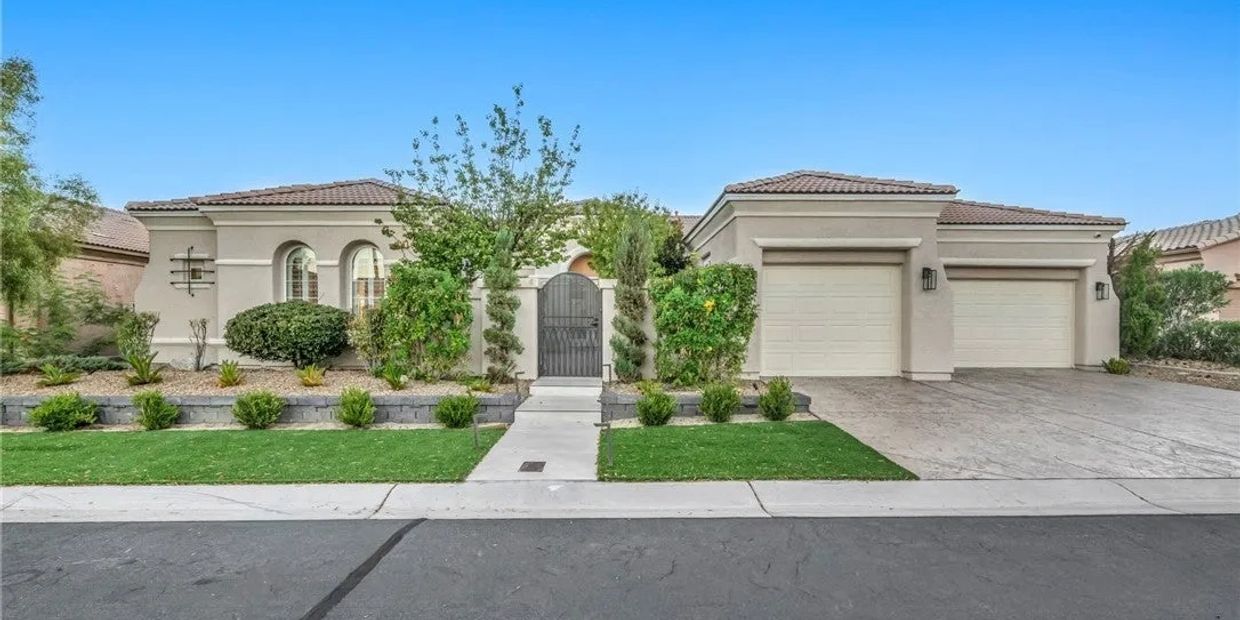 Single-story house with a three-car garage and gated entrance.