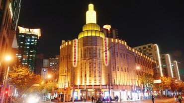 Illuminated historic building shining brightly at night in a cityscape.