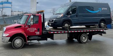 Chuckran's Towing Plate Bed Tow Truck. Towing A Large Cargo Van.