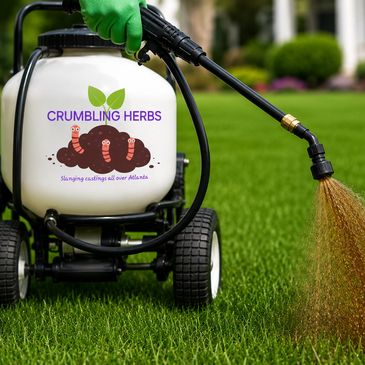 A garden sprayer labeled 'CRUMBLING HERBS' watering lush green grass.