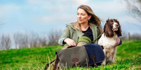 Lady with her dog and dog walking bags 