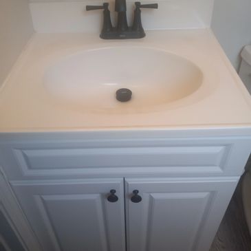 Bathroom cabinet, sink and faucet replacement.