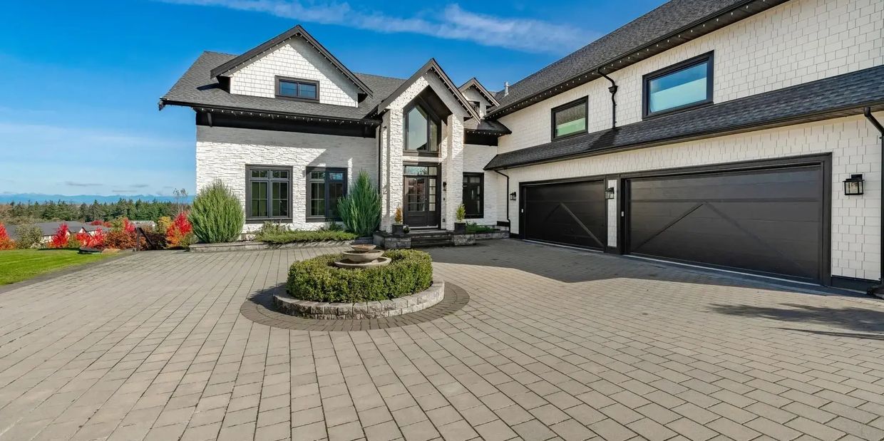 Single-family residential house with driveway and landscaped yard.