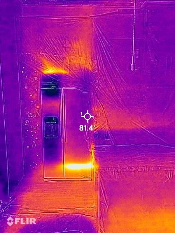 Thermal image showing heat around a refrigerator and adjacent furniture.
