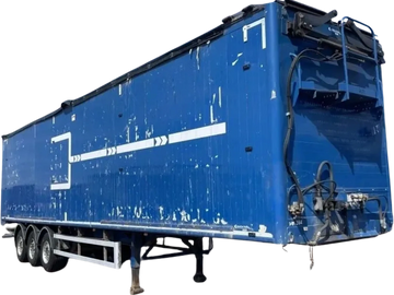 Blue semi-trailer truck container with white markings and signs of wear.