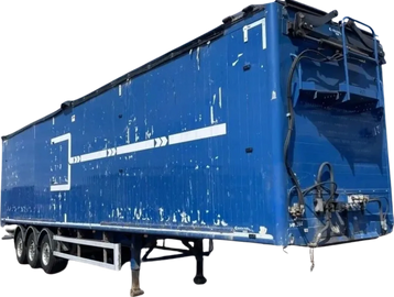 Blue semi-trailer truck container with white markings and signs of wear.