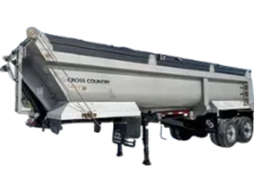 Large silver dump trailer with dual axles and support stands.