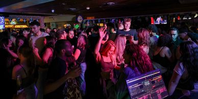 People dancing to music by the DJ