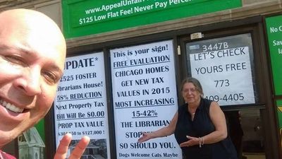 Two people posing with signs about tax evaluation and free checks.