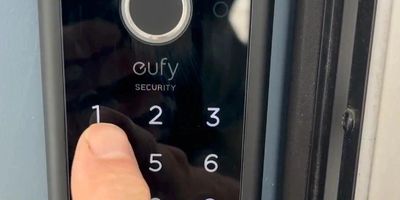 finger taping code into front door smart lock