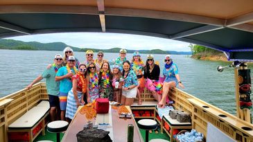 A large group of guests entities the broken tiki lake tour on beautiful broken bow lake. 