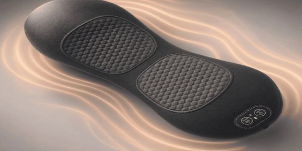 A sleek black massage cushion with quilted pads and control buttons.
