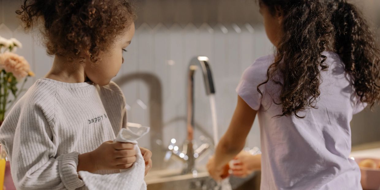 Girls washing their hands.