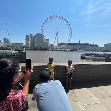 family taking photis at the london eye