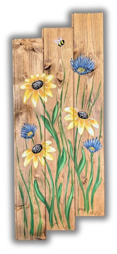 Wooden boards painted with yellow and blue flowers and a bee.