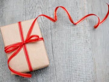 Image of a package with a beautiful red bow. 