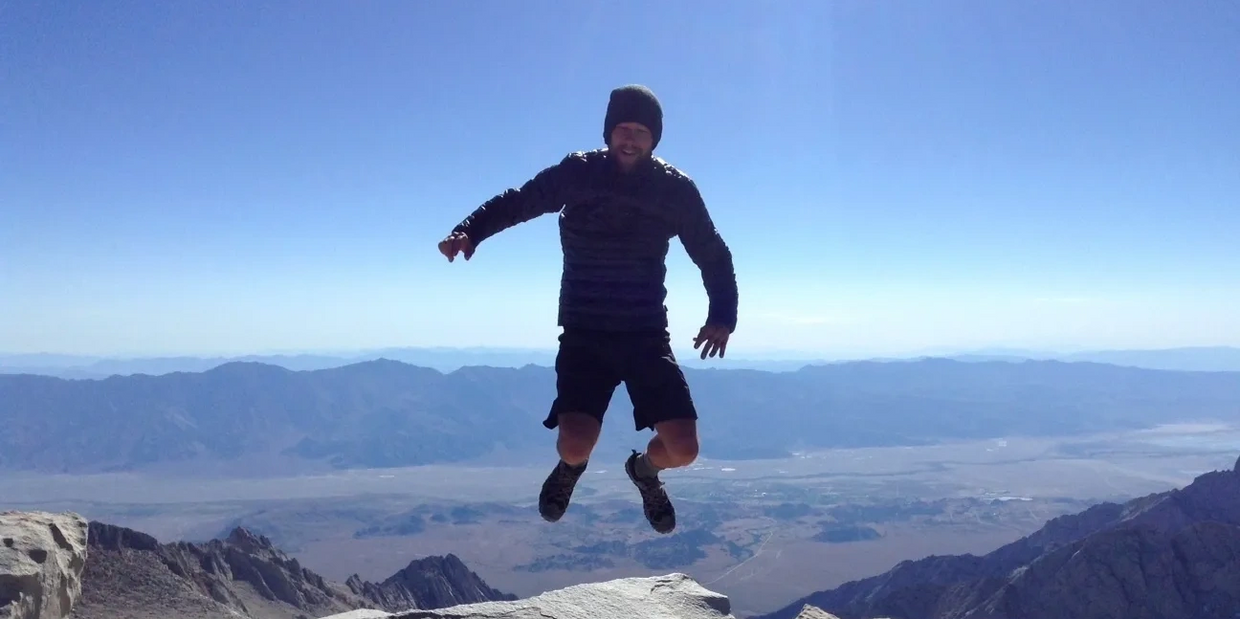 Tribhu jumping with joy on top of Mt. Whitney while thru-hiking the 2700 miles of the Pacific Crest 