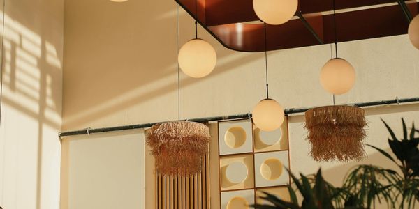 Modern interior with spherical pendant lights and natural textures.
