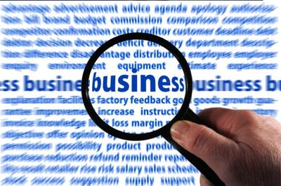 Magnifying Glass over the Word "business" in a Document Containing Business-related Words. 