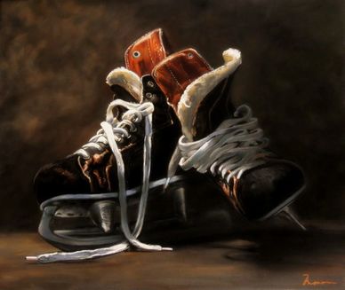 Pair of old leather ice skates with untied laces.