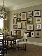 Elegant dining room with framed artworks and chandelier.