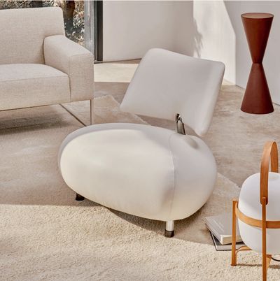 Modern white chair with rounded design in a bright living room.