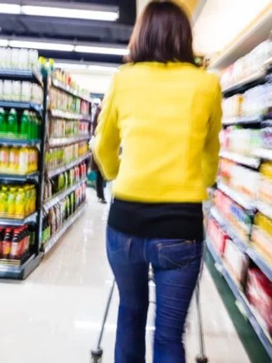 A woman shopping in a grocery store.