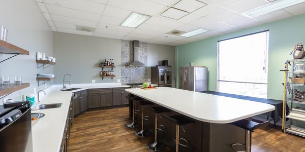 Modern kitchen with large island, bar stools, and ample storage.