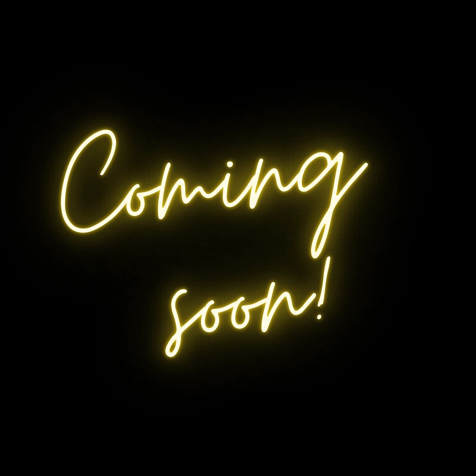 Yellow neon sign saying "Coming soon!" on a black background.