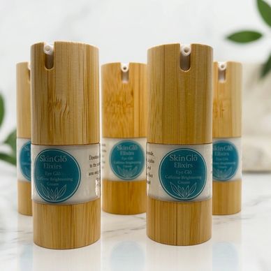 Eco-friendly bamboo containers of SkinGlo Elixirs skincare products.