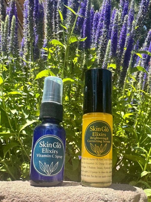 Vitamin C Spray is in a blue bottle, and the Brightening & Correcting Serum is in an orange bottle. 