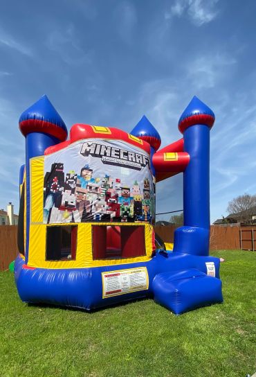 Minecraft-themed inflatable bounce house on a sunny lawn.