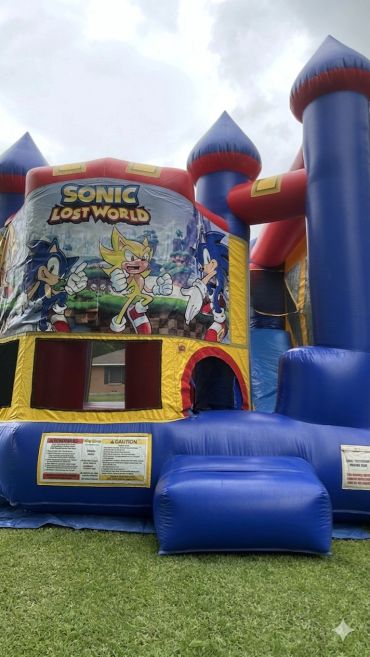 Colorful Sonic the Hedgehog themed inflatable bounce house outdoors.